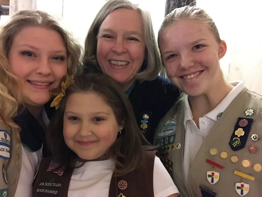 Girl scouts pose for a selfie.