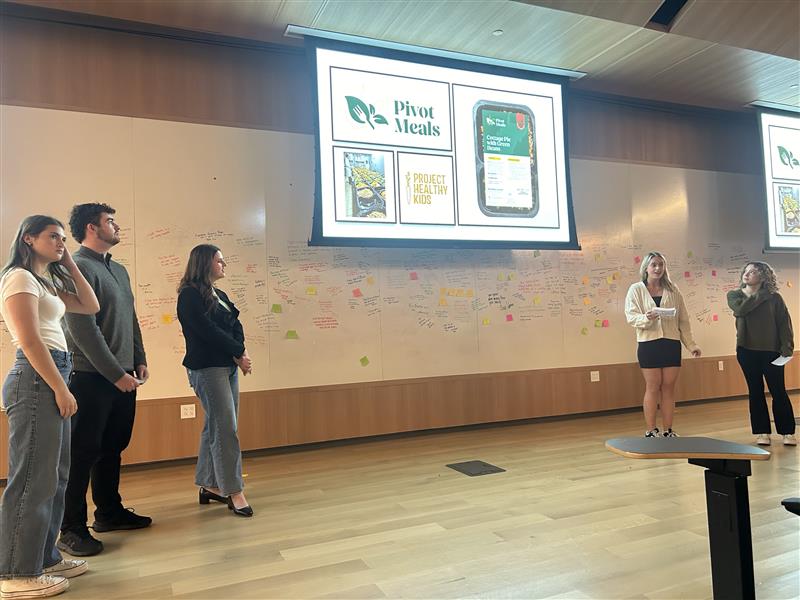 WVU students speaking infront of a class